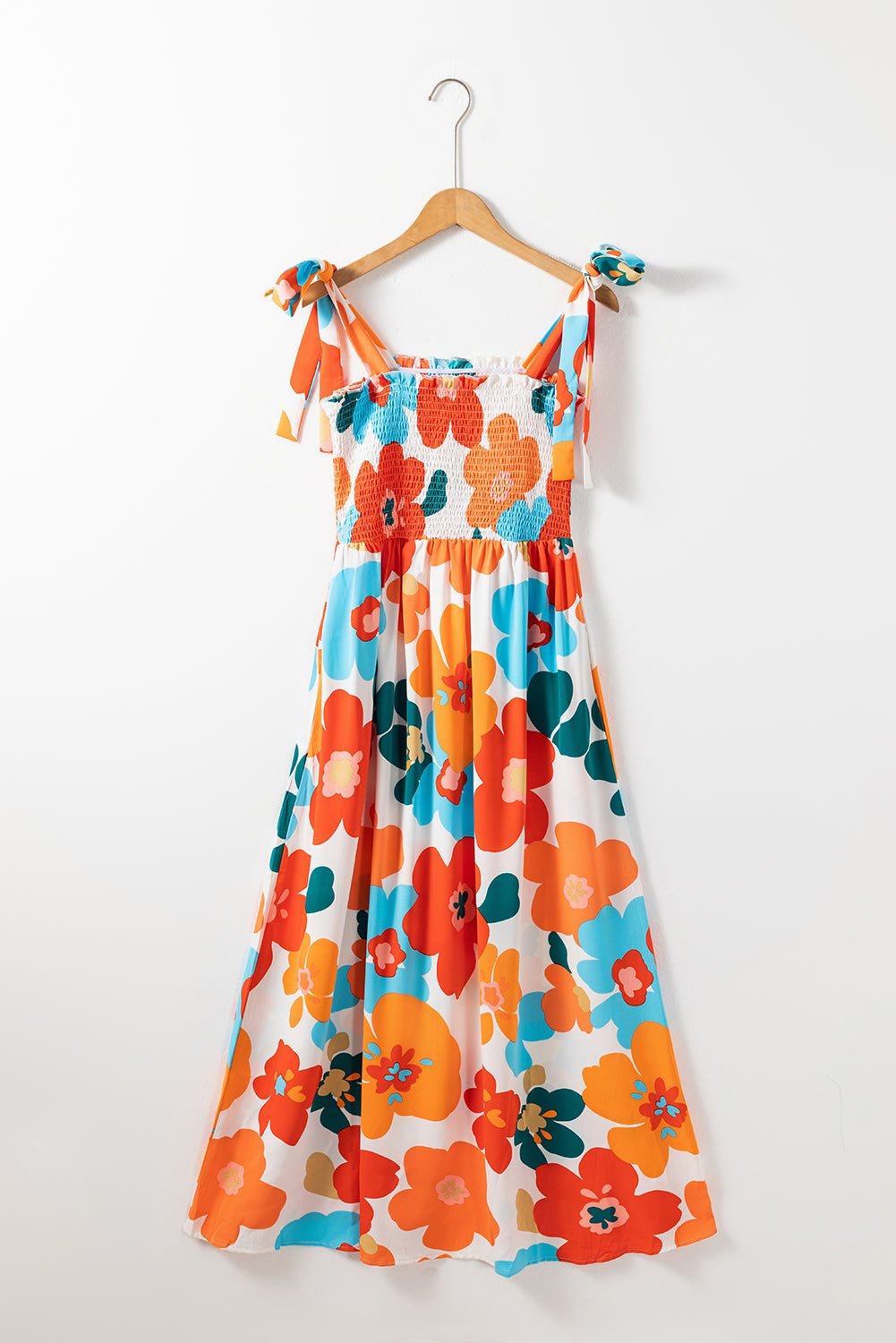 The image is showcasing a Women Floral Self Tied Straps Smocked Bust Maxi Dress With Pockets at Mommy & Lino's Closet