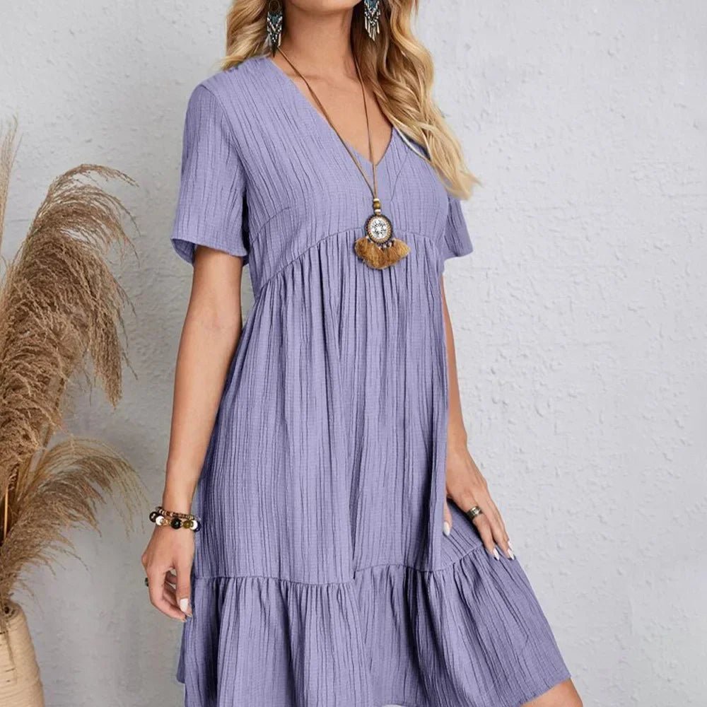 The image is showcasing a Women's Summer Casual V Neck Ruffle Mini Dress Short Sleeve A Line Bohemian Short Summer Dress Beach Sundress at Mommy & Lino's Closet